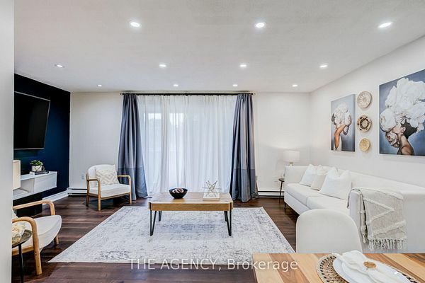 Living room seating area with terrace windows and sheer curtains