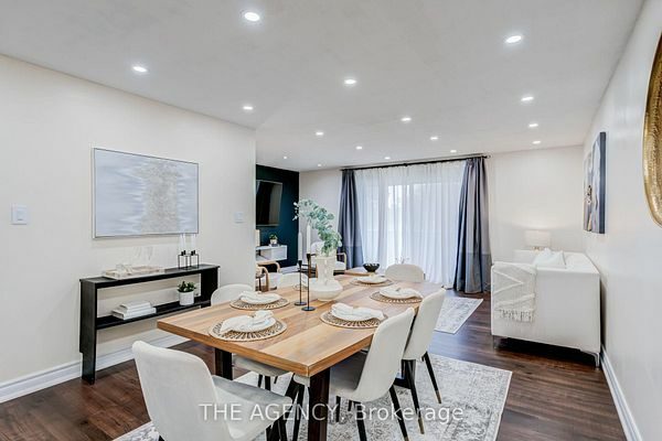 Dining area open to the living room with the navy feature wall beyond